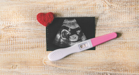 Ultrasound picture of a baby's photograph and accessories. Selective focus.
