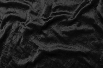 Abstract black fabric cloth texture background or liquid wave or wavy folds.