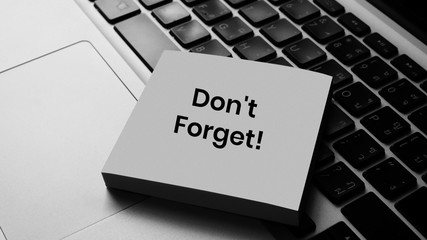 Don't forget message concept written post it on laptop keyboard	
