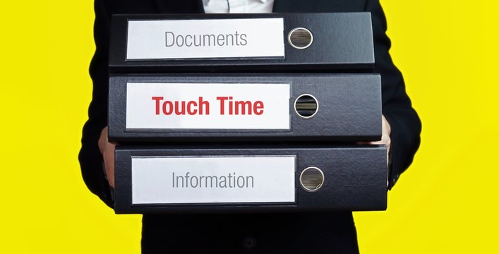 Touch Time. Businessman is carrying a stack of 3 file folders. Yellow background. Documents with word on label. Economy, Statistics, Finance
