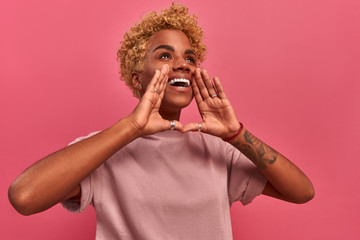 Positive pretty young african-american woman screaming out loud