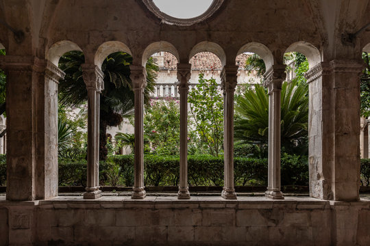 13th Century Franciscan Monastery cloister in the Old Town of Dubrovnik, Dalmatia, Croatia. Gothic romanesque style with columns and a botanical garden