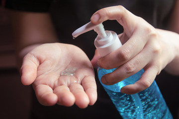 Woman using alcohol gel for cleaning hands prevention of coronavirus virus outbreak.