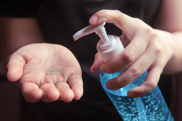 Woman using alcohol gel for cleaning hands prevention of coronavirus virus outbreak.