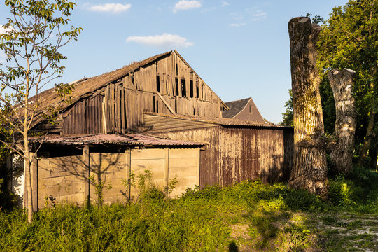 An old aged barn in Brabant, The Netherlands. Vintage broken farm house in a rural area , surrounded by greenery on a sunny day