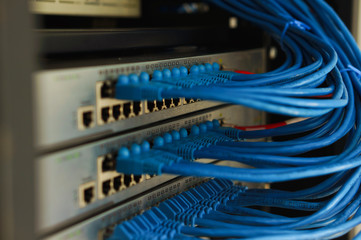 Closed data center Internet provider. Cable and switch connections. High speed internet network. Computer network. Ethernet telecommunication cables connected to an Internet switch. LAN