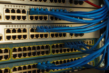 Closed data center Internet provider. Cable and switch connections. High speed internet network. Computer network. Ethernet telecommunication cables connected to an Internet switch. LAN