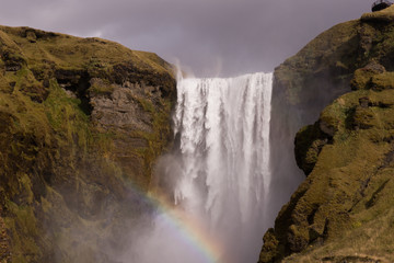 Nature view in Iceland. Famous Skogafoss waterfall with a rainbow 