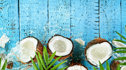 Fototapeta na wymiar Freeze Motion Top Shot of Water Splashing on Coconut, close-up