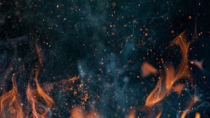 fire flames with sparks on a black background, close-up - obrazy, fototapety, plakaty