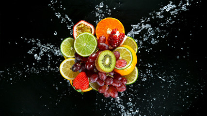 Fototapeta na wymiar Super Slow Motion Shot of Fresh Fruits with Splashing Water Isolated on Black Background.
