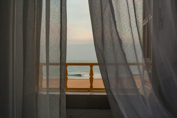 View of Nazare beach from the window of a house on the promenade