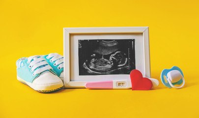 Ultrasound picture of a baby's photograph and accessories. Selective focus.