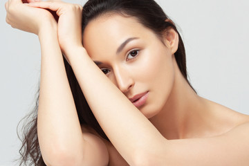 Portrait of young beautiful woman with clean perfect skin