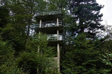Ruin of a tower made of concrete with guardrail spotted in the forest in the Vosges