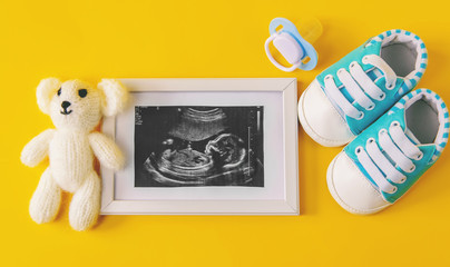 Ultrasound picture of a baby's photograph and accessories. Selective focus.