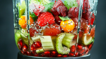 Fresh fruit and vegetables smoothie blended in blender, back view. Healthy eating concept.