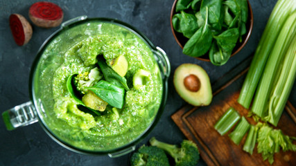 Green fresh smoothie blended in blender, top view. Healthy eating concept.
