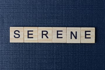 text on word serene from gray wooden letters on a black background