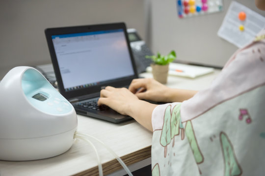 Mom Pump Milk And Work On Laptop In Office