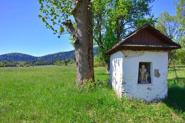 Old small chapel of Pensive Christ  in spring sunny day, Skwirtne village,
 Low Beskids (Beskid Niski), Poland.