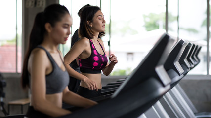 Asian friends treadmills run in gym