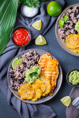 Rice with black beans, fried chicken breast and tostones, plantains © aamulya
