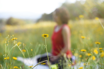 Yoga background with yellow flower and female silhouette with copy space.