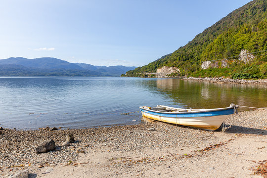 Boat anchored on the beach of the fjord of Puyuhuapi, Patagonia, Chile. Pacific Ocean