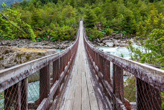 Wooden bridge over Ventisquero River on trail to Glacier, near the village of Puyuhuapi, Chile