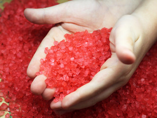 Red sea salt in children's hands.