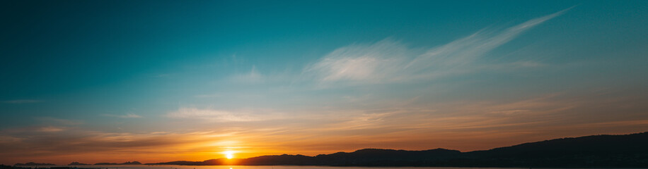 Obraz premium Panoramic sunset sky full of clouds