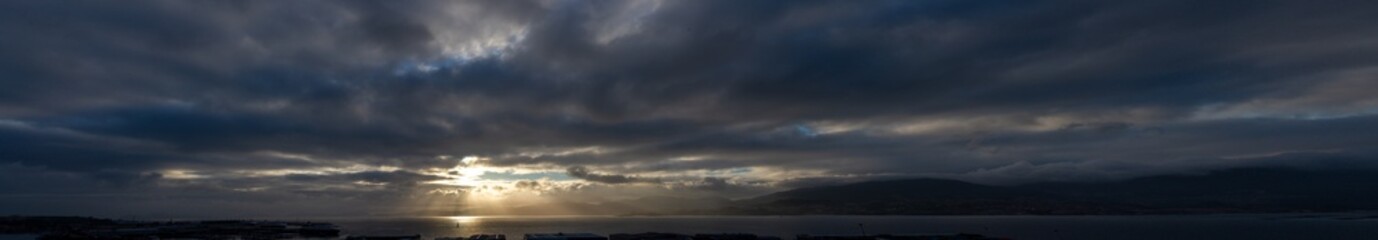 Fototapeta premium Panoramic storm sky with a spotlight