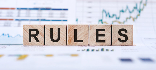 Closeup of word on wooden cubes on background financial concept - Rules