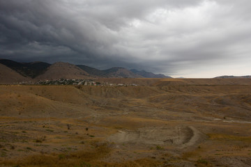 View of the rain clouds over the mountains. Gathering storm, dramatic scene. Sun Valley, Crimea.
