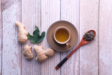 Top view of ginger tea on wooden background