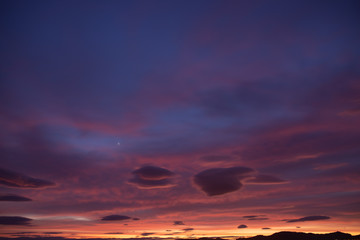 Fototapeta premium Sunset sky full of clouds with warm tones