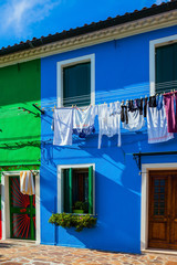 Colorful linens are dried on the balconies