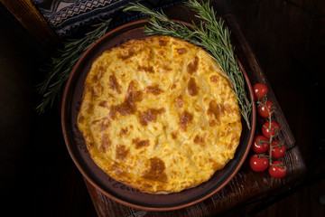 Hospitable Georgian cuisine. Khachapuri with cheese on a wooden background