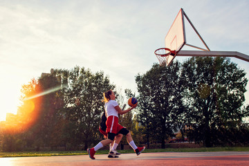 woman basketball player have treining and exercise at basketball court at city on street