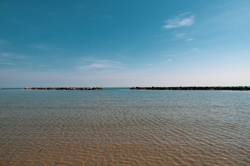 Social distancing after COVID lockdown in italian beach in the Riviera Romagnola area between Rimini and Riccione. Nobody around in a usually super crowded beach. Blue sky, clear water.