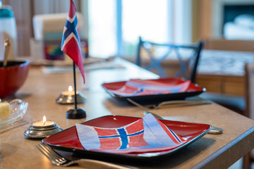 Norwegian Constitution Day celebration with festive table setting featuring Norway flag and patriotic napkins. May 17th.