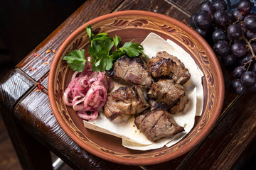 Grilled meat on pita with pickled onions and herbs