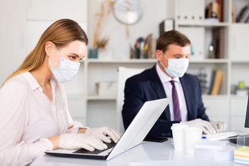 Office workers in protective medical masks