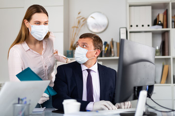 Director gives instructions to assistant in office