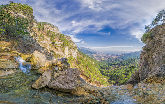 Panoramic view from top of the Uchan-su waterfall, that falls from the high rock mountain Ah-Petri in Crimea near Yalta. The concept of an travel, active and healthy life in harmony with nature.