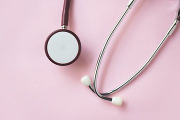 Medical stethoscope on pink background