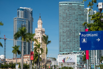 Historic Freedom Tower nestled between modern high-rise buildings in Miami, Florida.