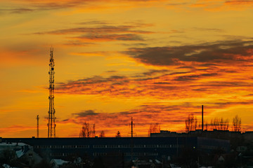 The colorful sky at sunset on a clear day plays with several colors , contrasting and rich beautiful view of the glow near the mountain and the city in winter