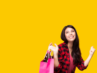 Enjoy shopping. Hold shopping bags, looking at copy space. Asian girl get fun and happy when products discount or on sale. Customer woman want to shopping with smiley face. She get joyful of shopping